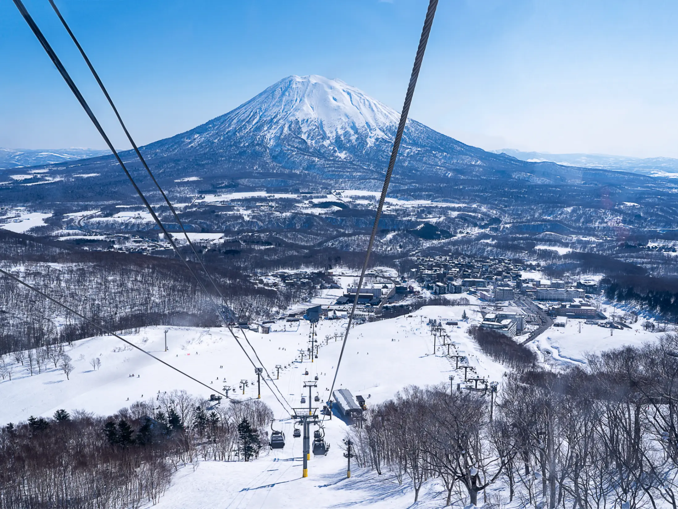View from chair lift across snowy mountains in Niseko, Japan