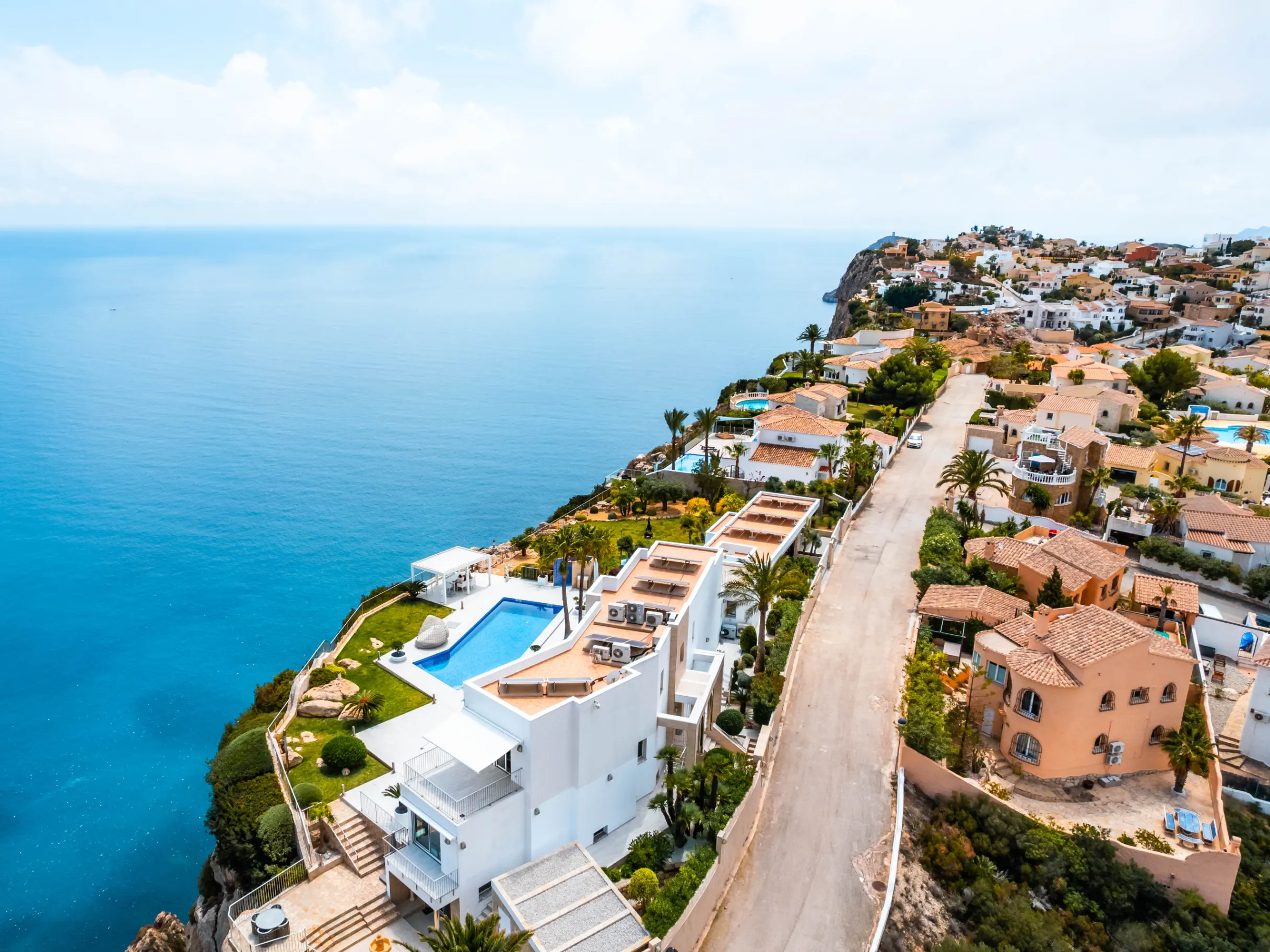 Flying with drone above luxury mansions on a cliff in the Alicante Costa Blanca, Spain
