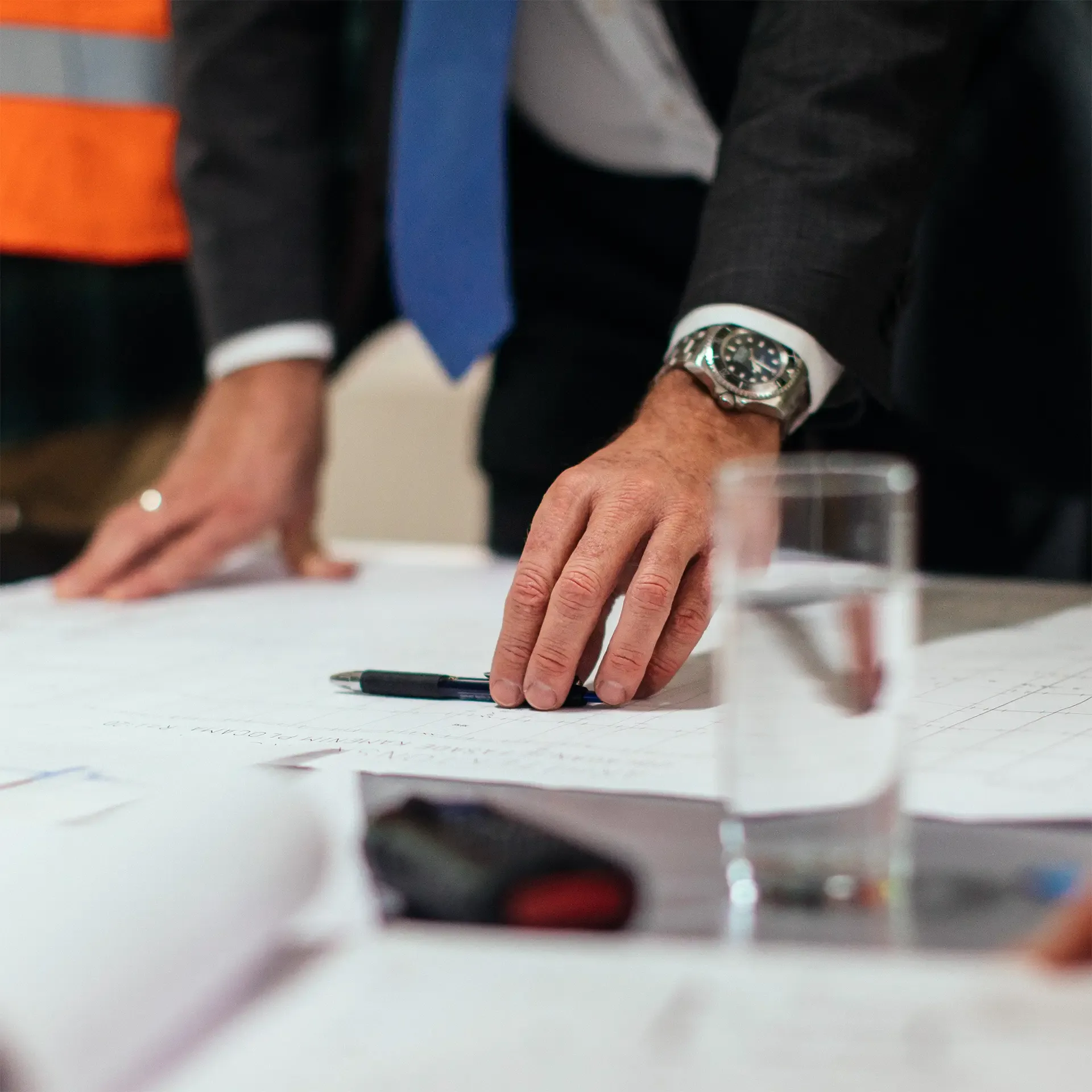 Person at a desk going over property plans in detail.