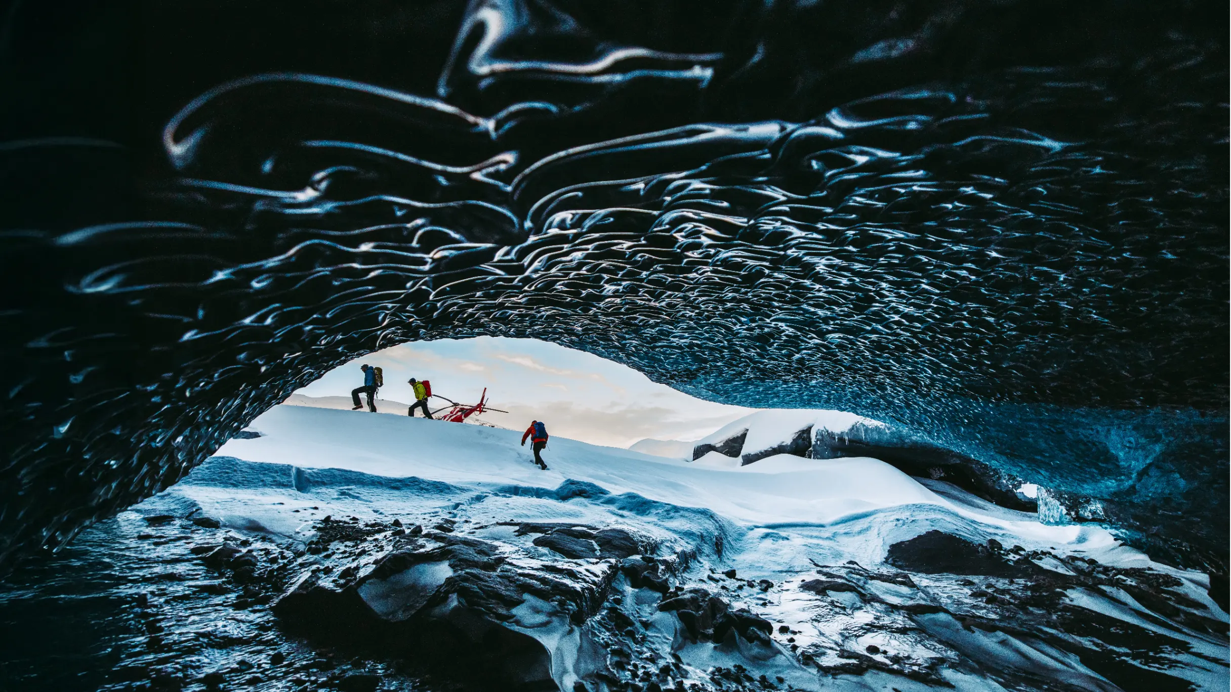People exploring an ice cave in Iceland