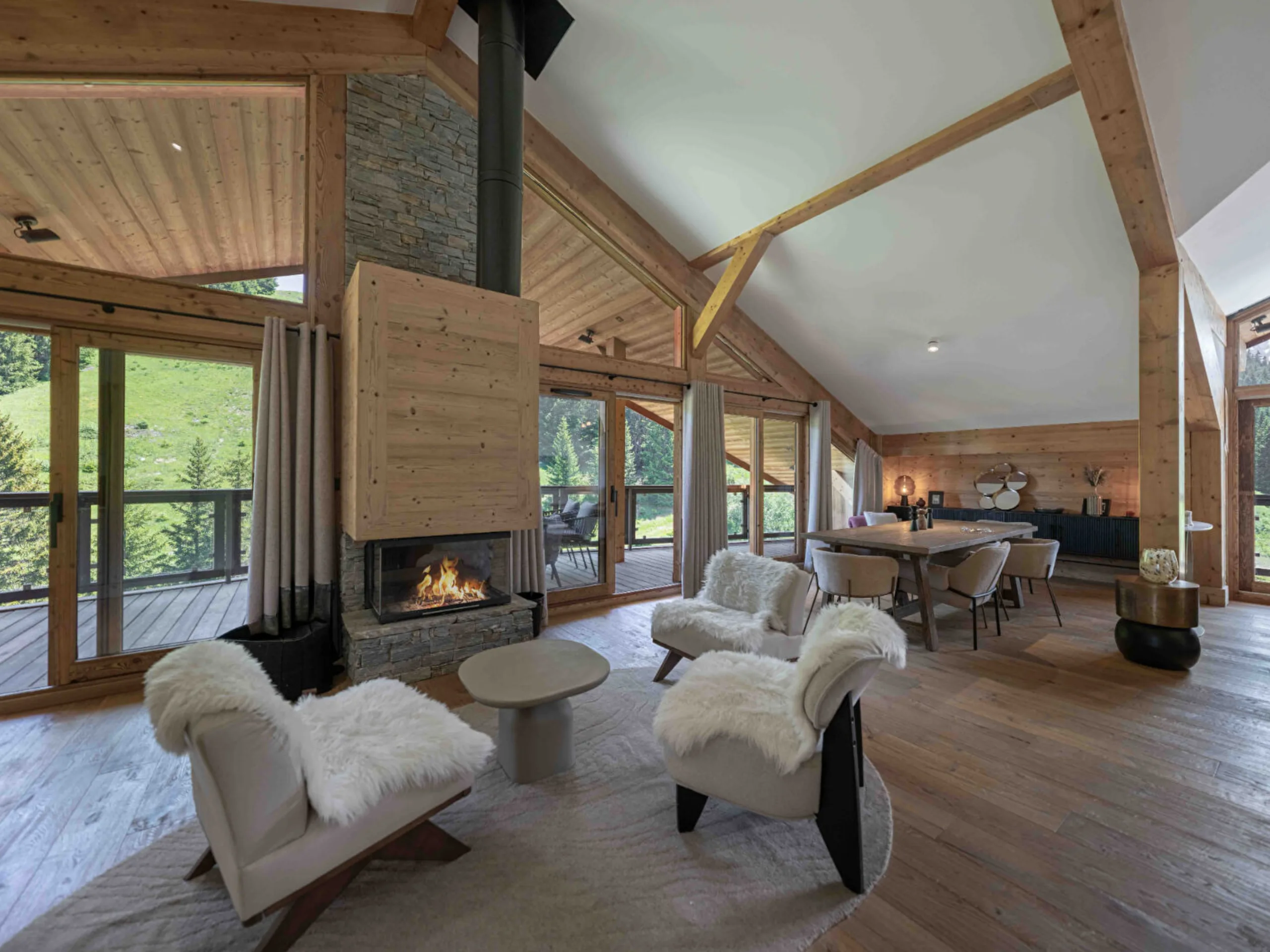 Luxurious interior of an Alpine chalet with timber floors and a burning log fire