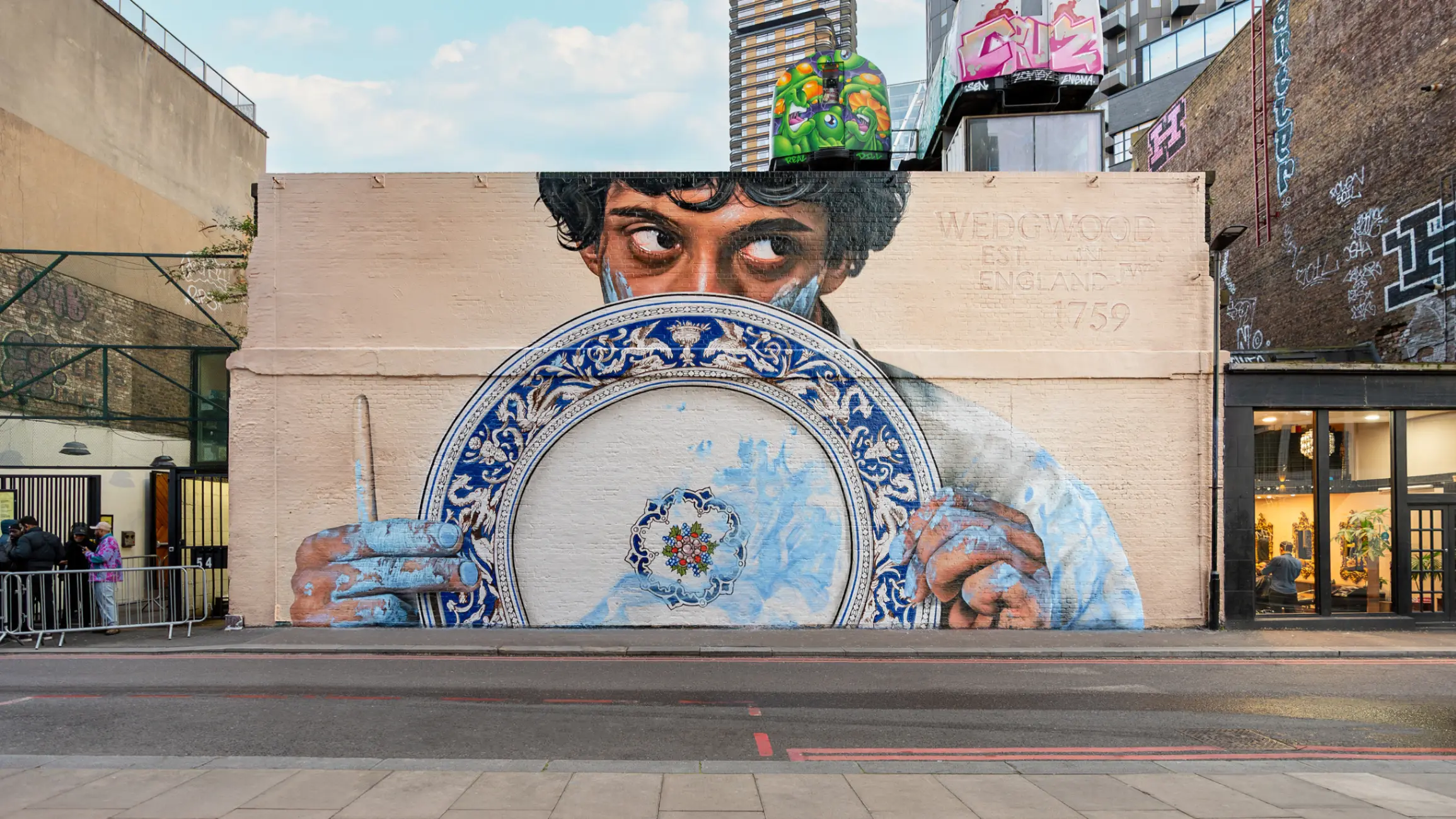 Mural by Navinder Nangla in Shoreditch London, depicting a person holding a Wedgwood plate.