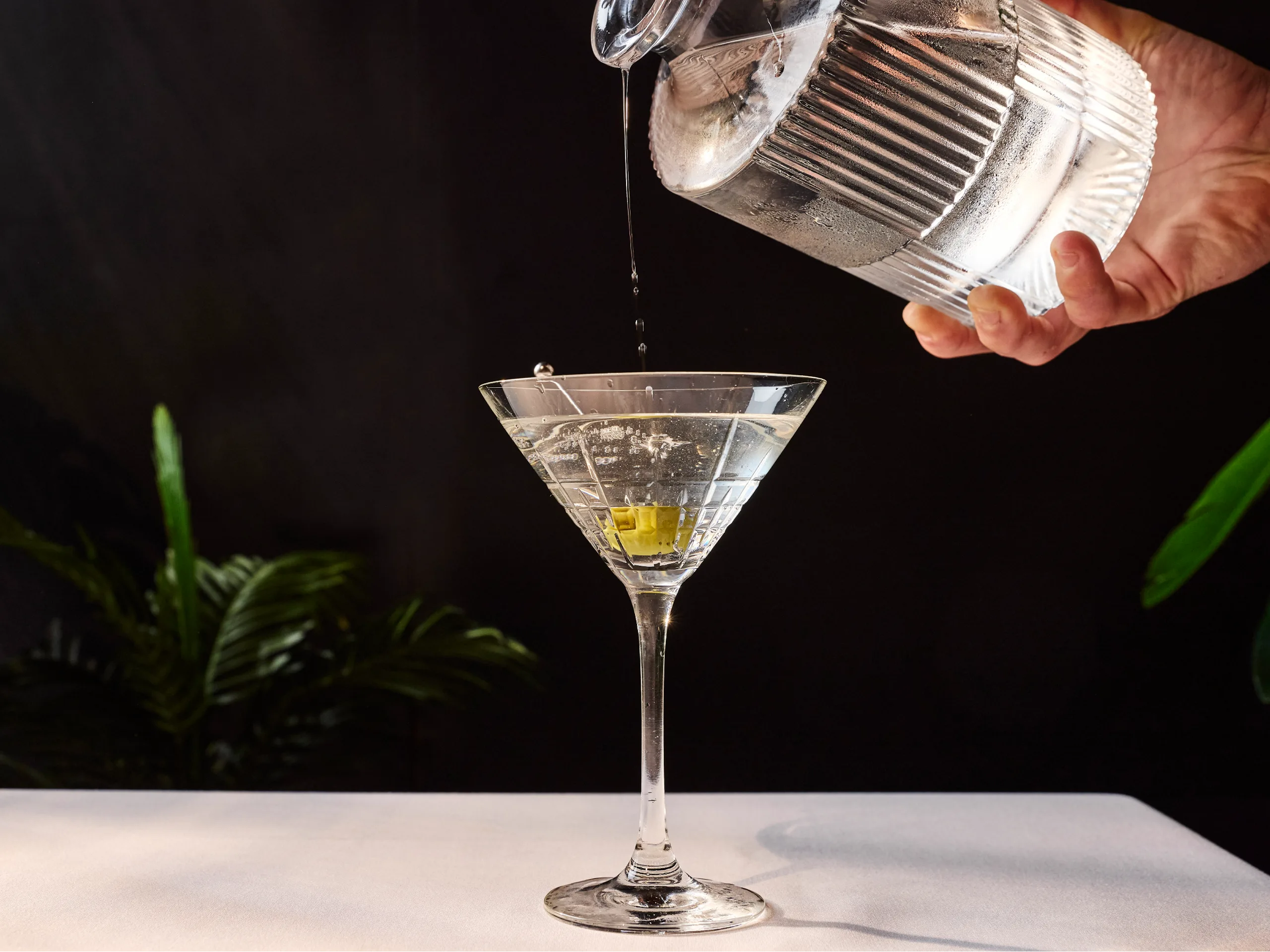 Bartender pouring martini cocktail